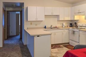 Menasha apartment for rent - A kitchen with white cabinets and appliances.