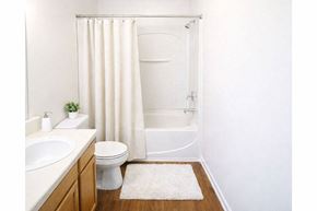 Nicholasville apartment for rent - A white bathroom with a toilet, sink, and shower.