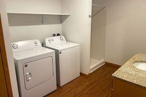 Viroqua apartment for rent - A small bathroom with a sink and two toilets.