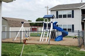 Winfield apartment for rent - A playground with a blue slide and a white and blue tower.