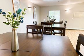 St. Cloud apartment for rent - a dining room table with a vase of flowers on it