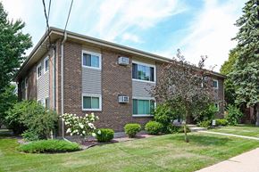 Wisconsin Rapids apartment for rent - A brick apartment building with a green lawn in front.