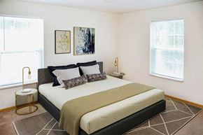 Quincy apartment for rent - a bedroom with a bed and two windows
