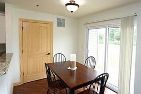 Waukesha apartment for rent - a dining room with a wooden table and chairs
