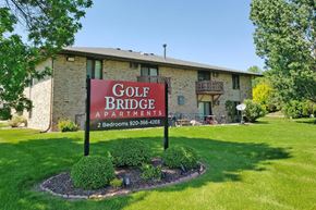 Neenah apartment for rent - a golf bridge apartments sign in front of a building