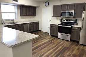 Clear Lake apartment for rent - a kitchen with stainless steel appliances and wooden floors