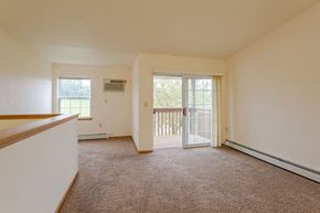 Milton apartment for rent - an empty living room with a door to a balcony