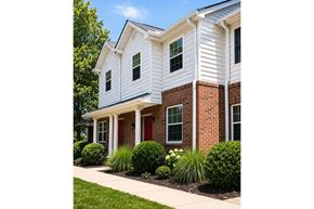 Nicholasville apartment for rent - A white house with a red door and brick pillars.
