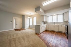 Hartford City apartment for rent - A kitchen with white cabinets and a refrigerator.