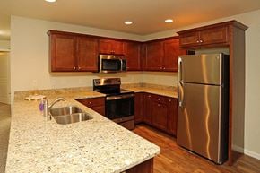 Mukwonago apartment for rent - a kitchen with stainless steel appliances and granite counter tops