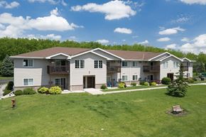 Ripon apartment for rent - a large white house with a green lawn and trees