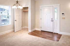 Knightstown apartment for rent - A room with a white door, a chandelier, and a window with blinds.
