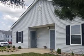 Atlantic apartment for rent - A house with a grey door and windows.
