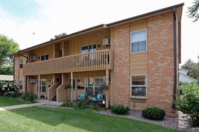 Wisconsin Rapids apartment for rent - A two-story brick building with a balcony on the second floor.