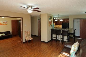 La Crosse apartment for rent - A living room with a brown leather couch and a wooden floor.