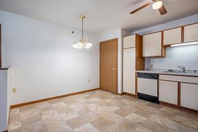 Stevens Point apartment for rent - A kitchen with a tile floor and a ceiling fan.