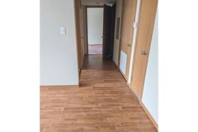 South Charleston apartment for rent - A hallway with wood flooring and white walls.