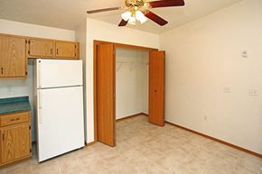 Sturgeon Bay apartment for rent - a kitchen with a white refrigerator and a ceiling fan