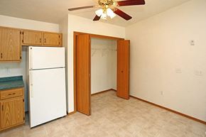 Sturgeon Bay apartment for rent - a kitchen with a white refrigerator and a ceiling fan