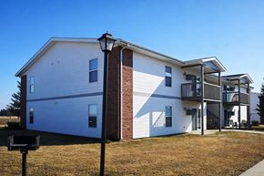 Galesburg apartment for rent - A two-story house with a garage on the first floor and a balcony on the second floor.