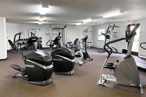 St. Cloud apartment for rent - a gym with various exercise equipment in it