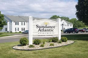 Atlantic apartment for rent - A sign for Sudance Atlantic Apartments is in front of some houses.