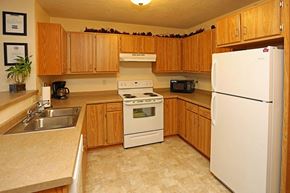 Appleton apartment for rent - a kitchen with white appliances and wooden cabinets