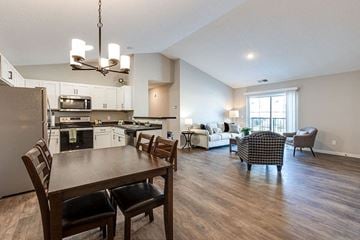 Hugo apartment for rent - a kitchen and living room with a table and chairs