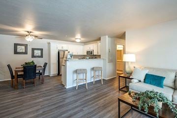 Oshkosh apartment for rent - a living room and kitchen with a couch and a table