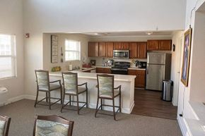 Hopkinsville apartment for rent - A kitchen with a dining table and chairs.