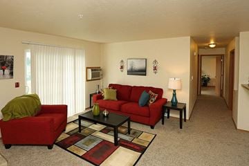 Neenah apartment for rent - a living room with a red couch and a table