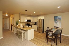 Sheboygan apartment for rent - A kitchen with a table and chairs in front of it.