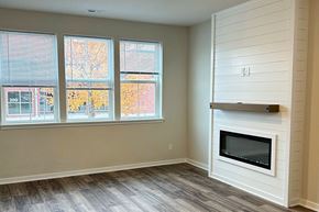 Beaver Dam apartment for rent - A room with a fireplace and a window showing trees outside.