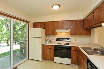 Hartland apartment for rent - A kitchen with a white refrigerator and wooden cabinets.