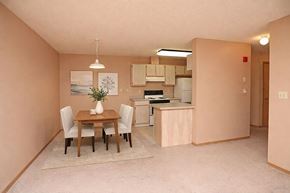 Yankton apartment for rent - A kitchen with a table and chairs in the middle of the room.