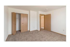 Bismarck apartment for rent - a bedroom with two doors and a carpet floor
