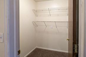 Rifle apartment for rent - A white wall with three shelves and a door.