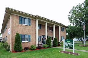 Manitowoc apartment for rent - a brick building with a sign in front of it