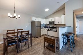 Hugo apartment for rent - a kitchen and dining room with a table and chairs
