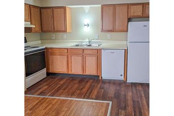 South Charleston apartment for rent - A kitchen with wooden cabinets and a white refrigerator.
