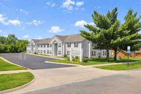 Marshalltown apartment for rent - A large building with a driveway in front of it.