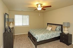 Mukwonago apartment for rent - a bedroom with a bed and a ceiling fan