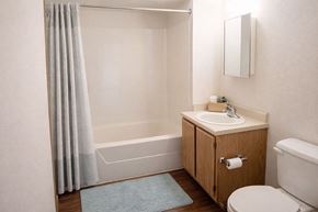 Hays apartment for rent - A bathroom with a sink, toilet, and bathtub.