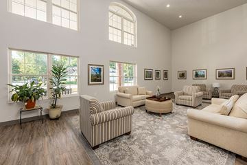 Terre Haute apartment for rent - A living room with a striped couch and a coffee table.
