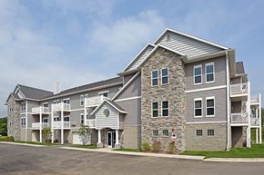 Waukesha apartment for rent - a large apartment building with a parking lot