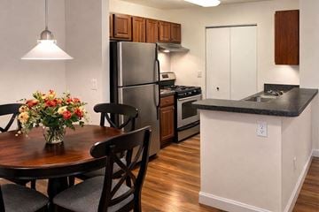 Kalamazoo apartment for rent - A kitchen with a table and chairs and a refrigerator.