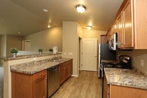 Oshkosh apartment for rent - a kitchen with granite counter tops and wooden cabinets