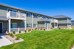 Oshkosh apartment for rent - an apartment building with a yard and a balcony