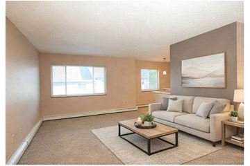 Yankton apartment for rent - A living room with a couch, coffee table, and a painting on the wall.