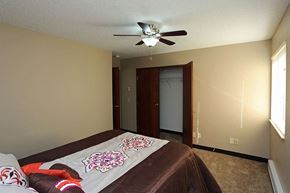 La Crosse apartment for rent - A bedroom with a bed and a ceiling fan.